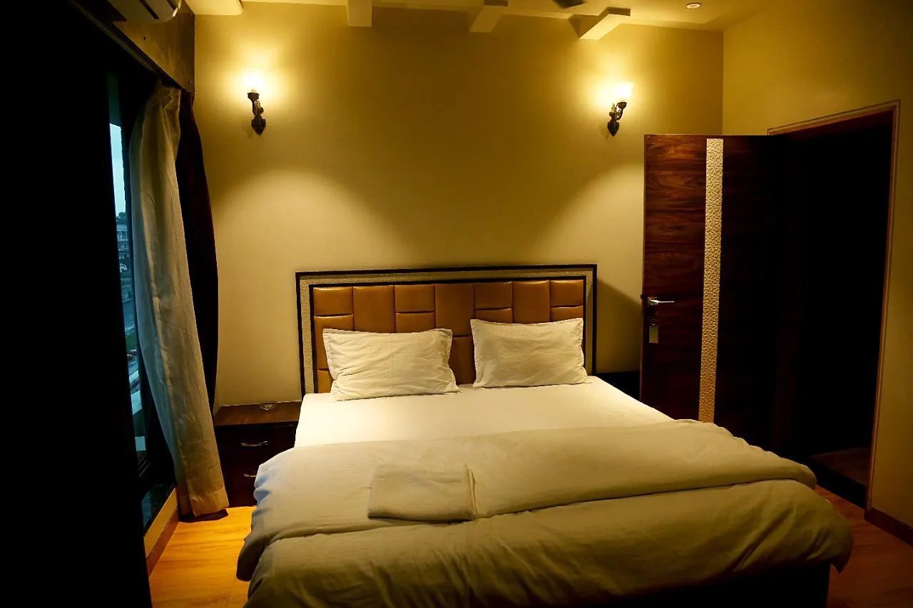 Evershine bedroom with padded headboard and wall lamps
